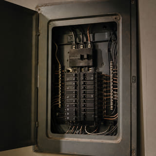 An open breaker panel with neatly dressed wiring.